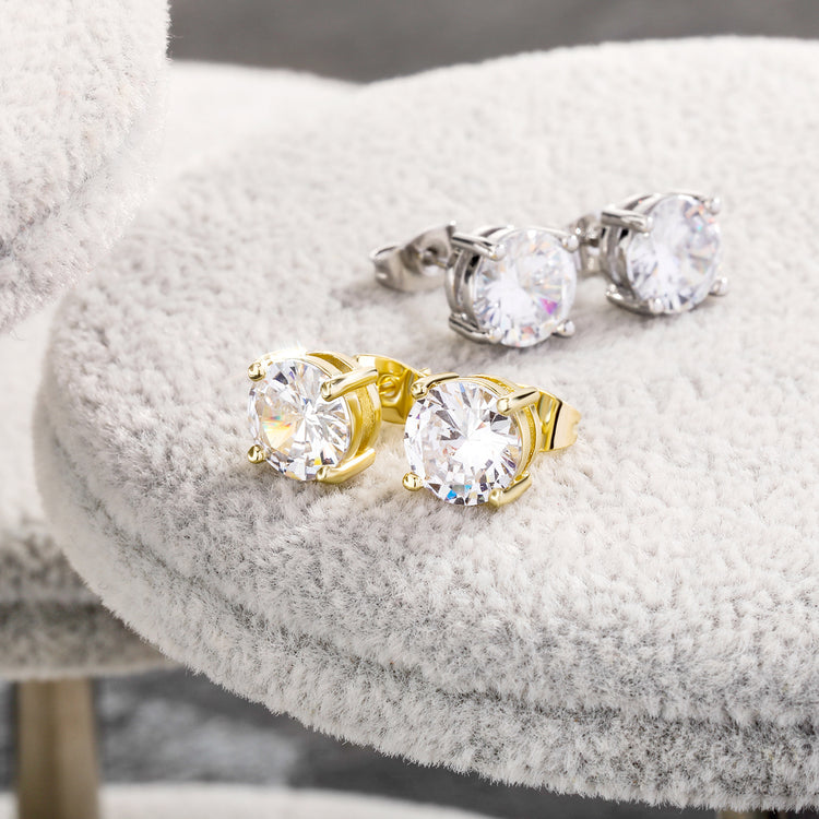 AngShop round zirconia earrings hip hop style in gold and silver settings on a gray textured surface