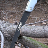 AngShop compact pruning saw cutting through tree branches with sharp serrated blade