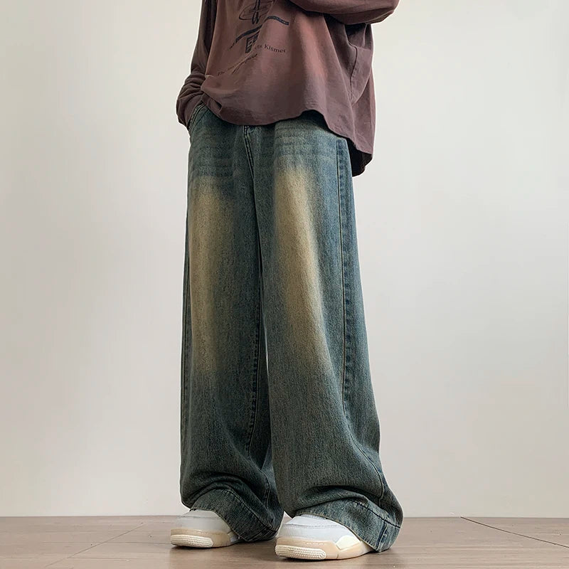 AngShop distressed wide leg jeans in faded blue denim worn with casual sneakers