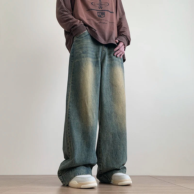 AngShop distressed wide leg jeans in faded blue worn with casual brown long sleeve shirt and white sneakers