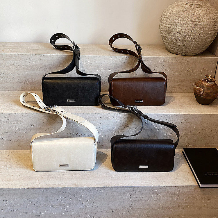 Functional elegant purse women in black brown white and dark brown leather by AngShop displayed on stone shelves