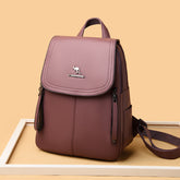 Functional leather-look backpack for daily use in brown with front zipper pockets and top handle