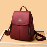 Functional leather-look backpack for daily use in burgundy with zippered pockets and adjustable straps