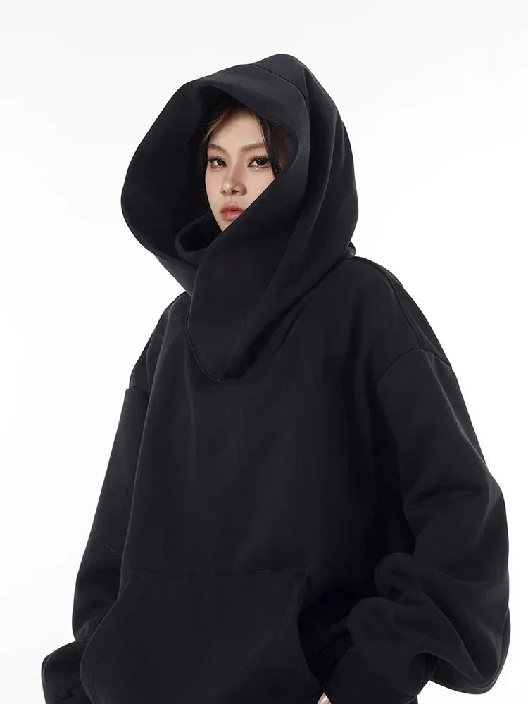Black Harajuku fashion hoodie unisex with oversized hood and relaxed fit worn by model