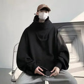 Black oversized Harajuku fashion hoodie unisex styled with gray pants and a brown cap