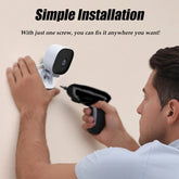 Man installing AngShop white indoor surveillance camera on wall using power drill for simple installation