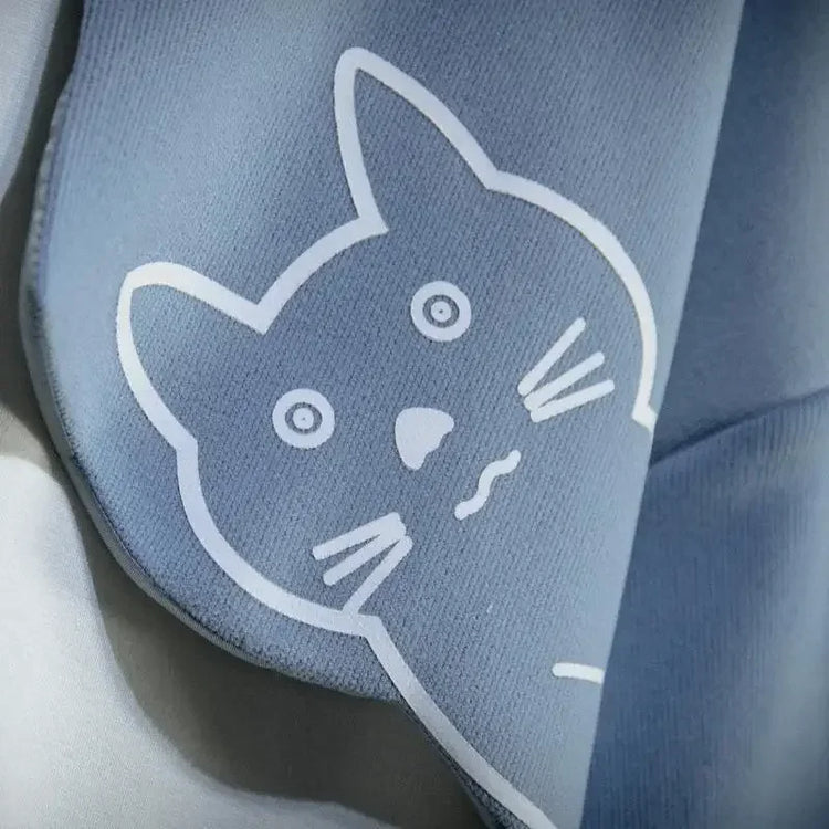 Close-up of blue fabric with a white outline cat face print on cute cat anime hoodie from AngShop