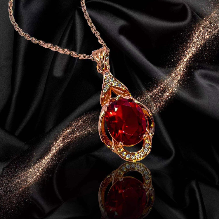 Elegant red tourmaline necklace and earrings with a deep red gemstone and gold detailing by AngShop