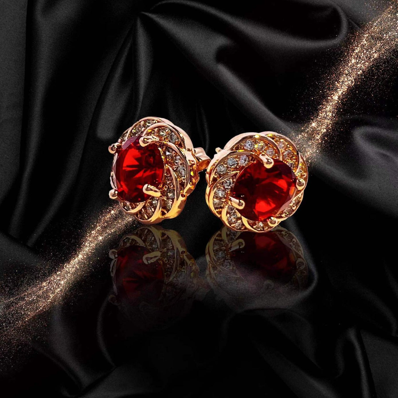 Elegant red tourmaline necklace and earrings featuring gold settings with sparkling accents