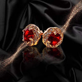 Elegant red tourmaline necklace and earrings featuring gold settings with sparkling accents