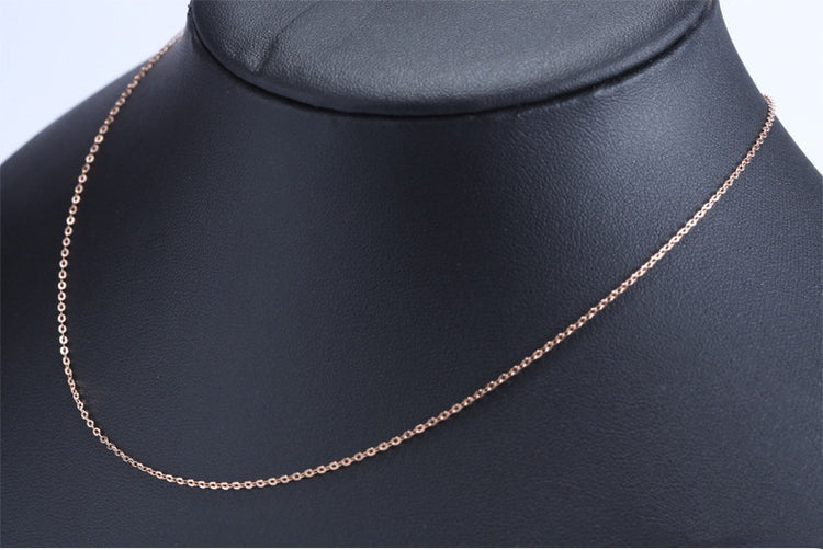 Elegant red tourmaline necklace and earrings chain displayed on a black jewelry bust