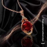 Elegant red tourmaline necklace and earrings pendant with gold setting on black satin background