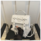 Elegant small PU leather bag in white with heart and bow design, handheld and shoulder strap by AngShop