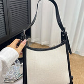 Elegant stitched handbag for women in black and beige with adjustable strap by AngShop