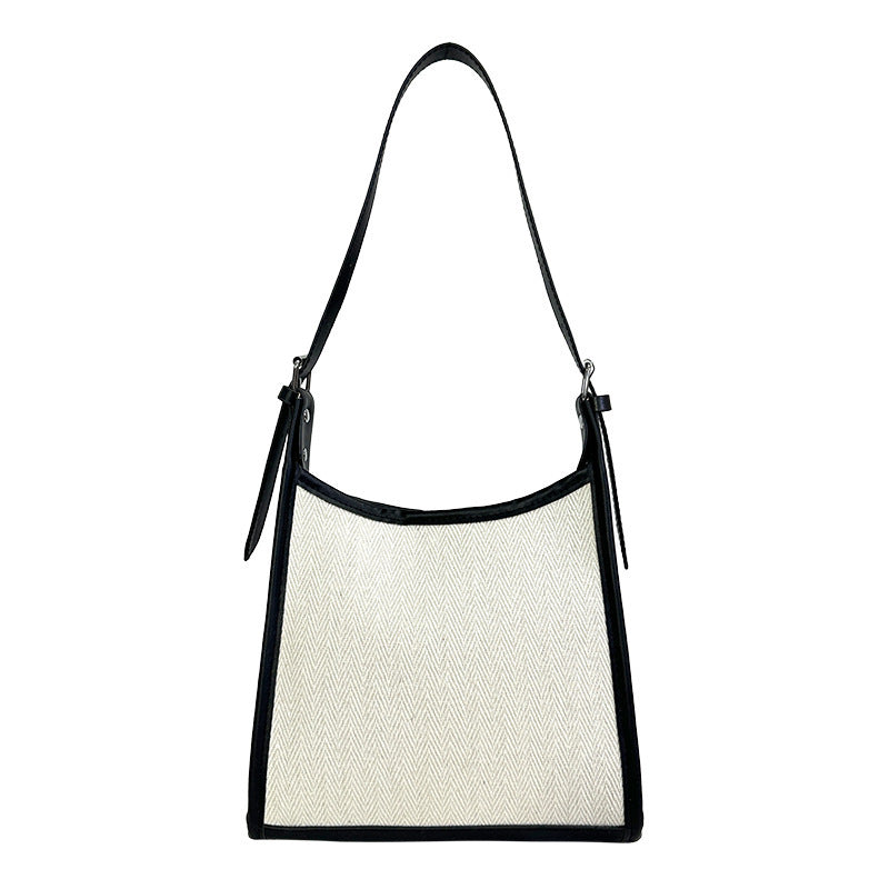 Elegant stitched handbag for women in white and black with adjustable shoulder strap