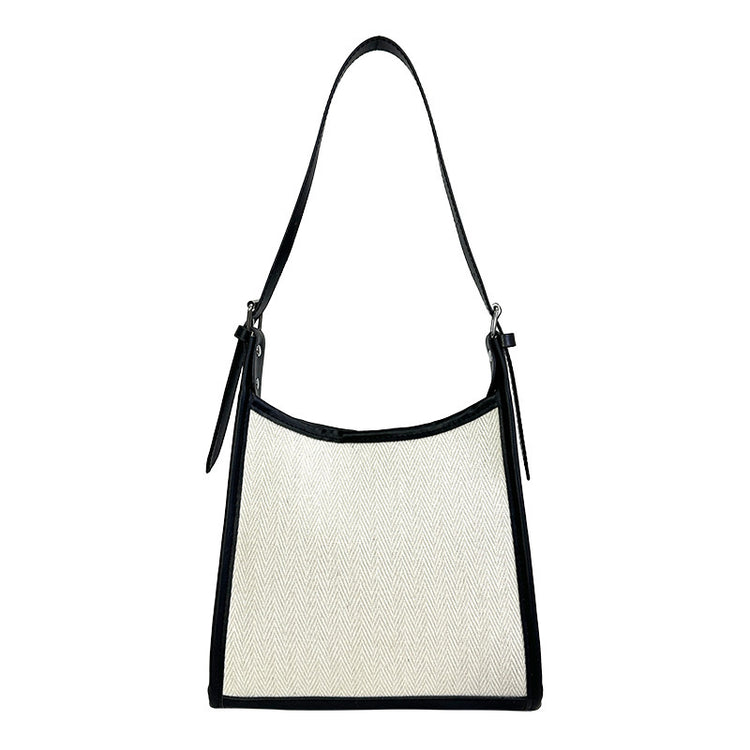Elegant stitched handbag for women in white and black with adjustable shoulder strap