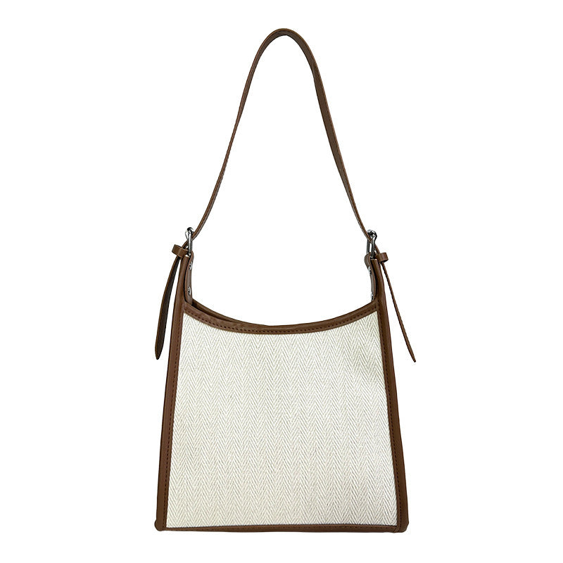 Elegant stitched handbag for women with brown trim and adjustable shoulder strap