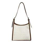 Elegant stitched handbag for women with brown trim and adjustable shoulder strap