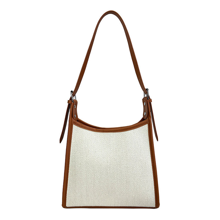 Elegant stitched handbag for women in white fabric with brown leather trim and shoulder strap