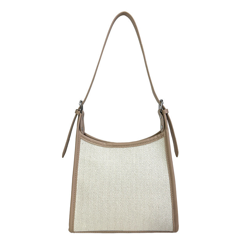 Elegant stitched handbag for women in beige and cream with a single shoulder strap