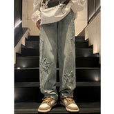 AngShop grey gothic streetwear pants with star patches worn with white graphic sweatshirt and sneakers