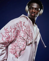 Vintage Y2K hoodie unisex with pink cherry blossom tree design worn by a man with headphones