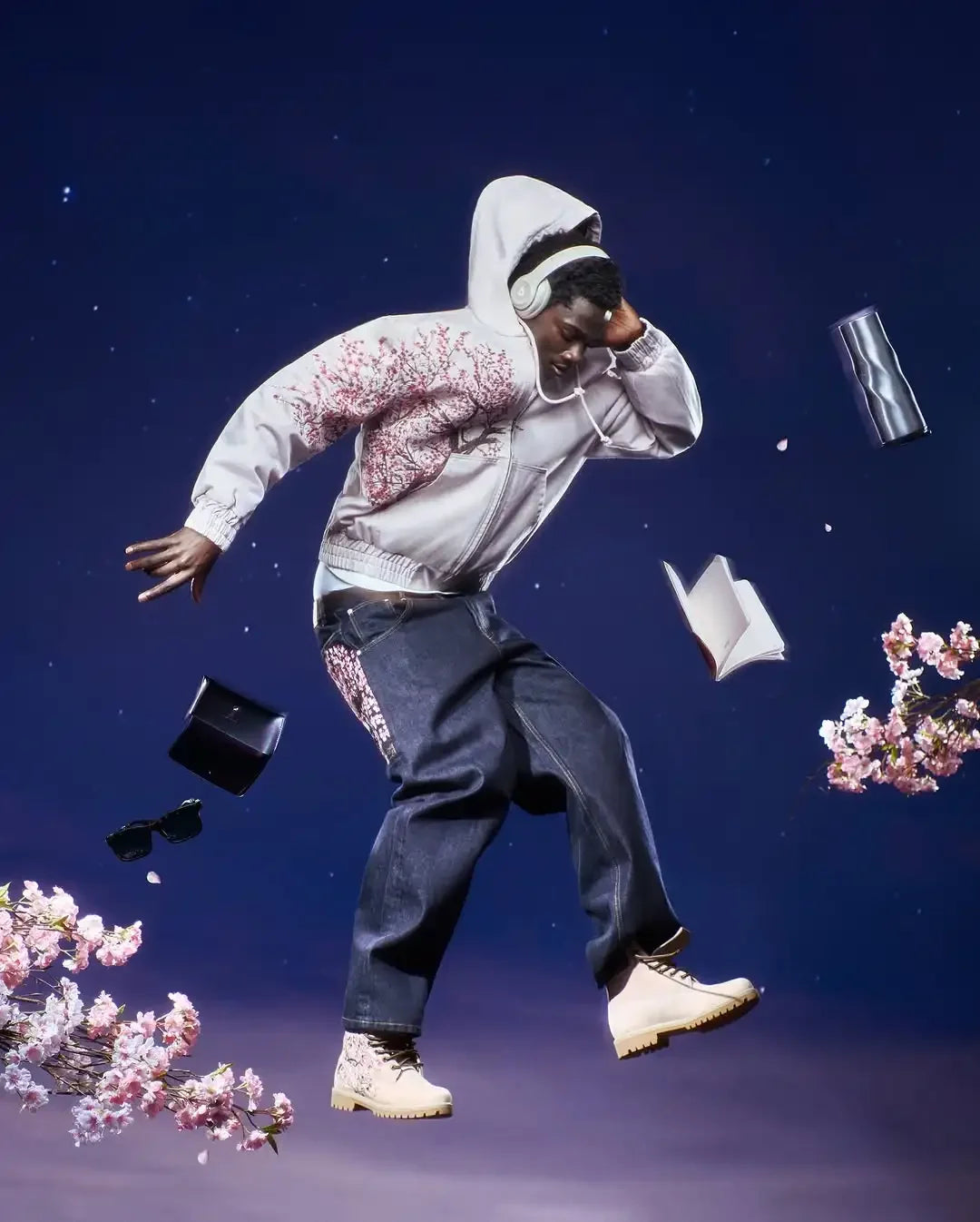 Man wearing a vintage Y2K hoodie unisex with floral design, dark jeans, and beige boots against a starry sky background